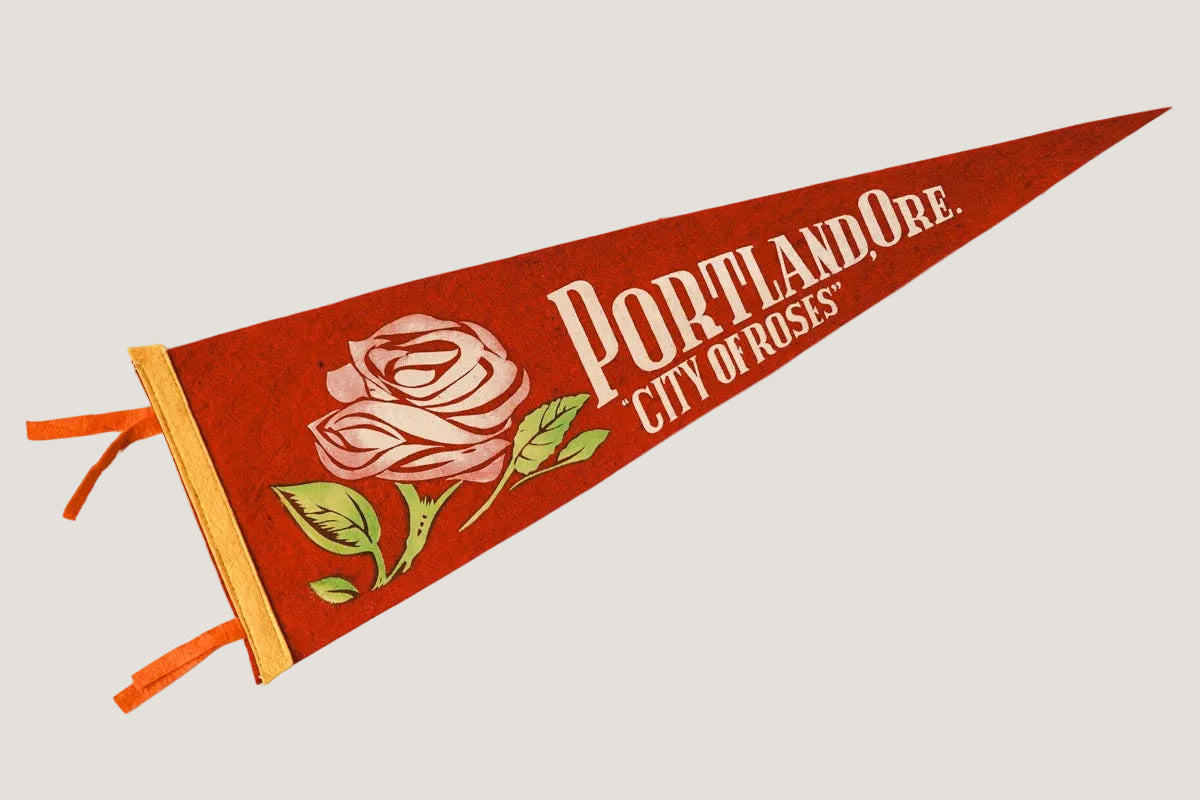 Pennant with 'Portland, Ore. City of Roses' text and rose design on a white background