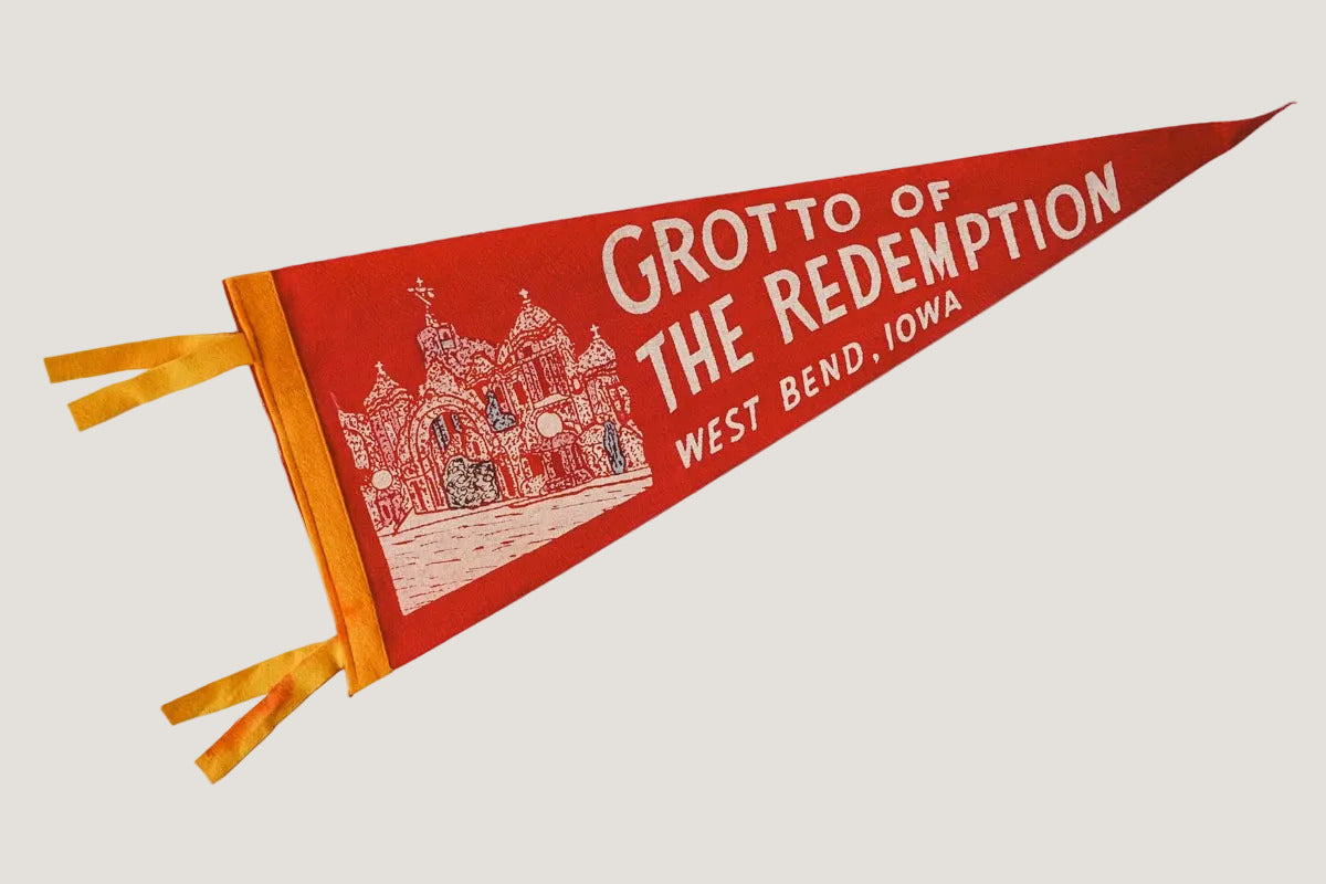 Red and yellow pennant with 'Grotto of the Redemption, West Bend, Iowa' text on a white background
