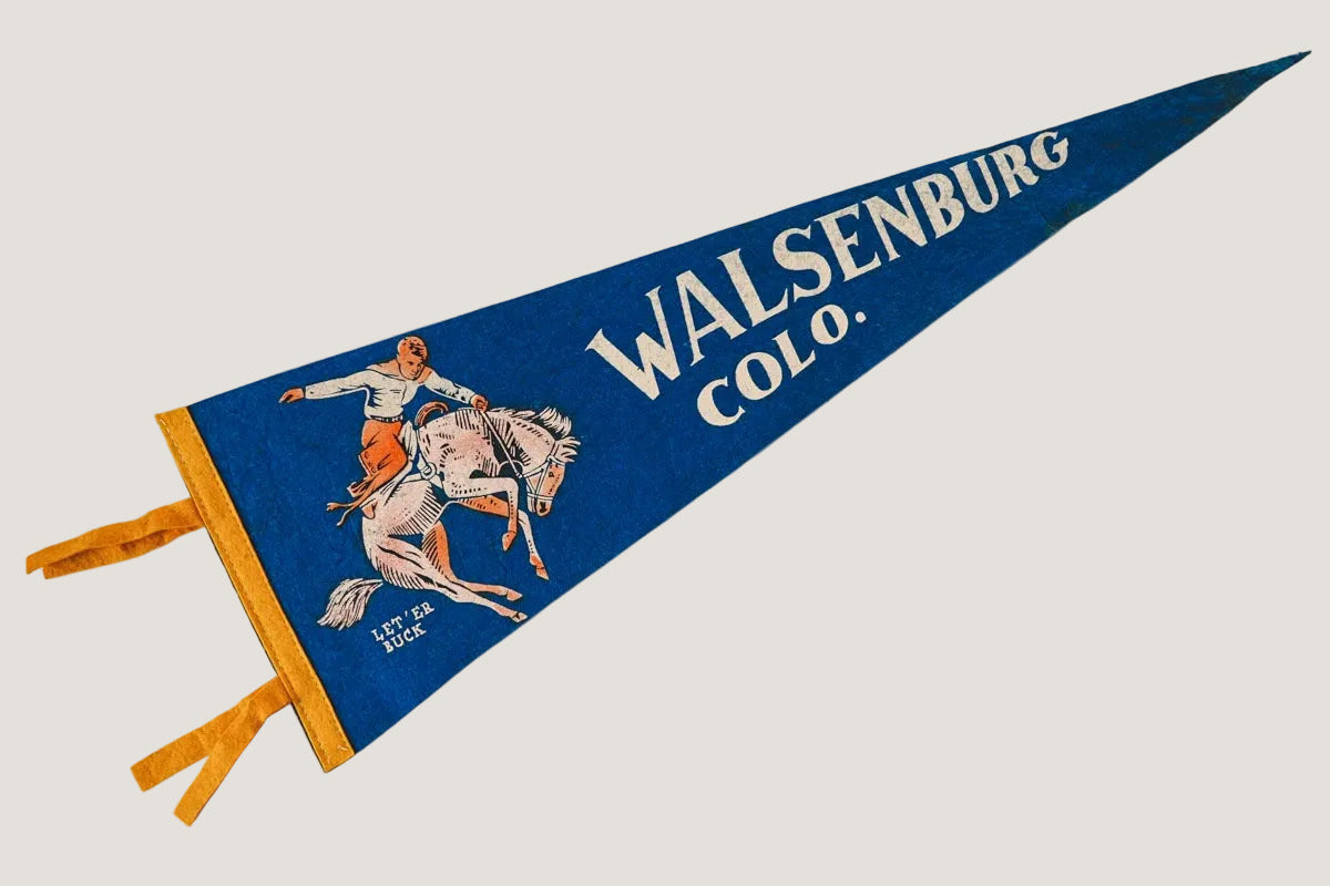 Vintage-style pennant with 'Walsenburg Colo.' text and graphic on a white background