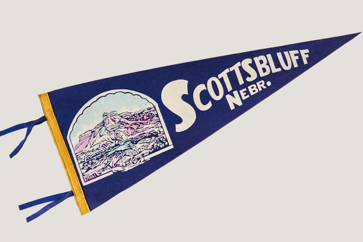 Vintage-style pennant with 'Scottsbluff Nebr.' text on a white background