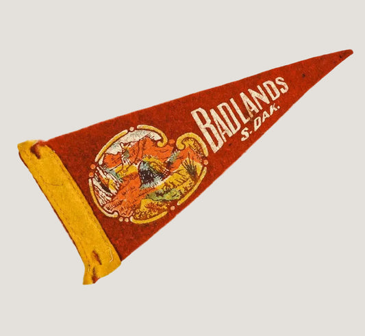 Vintage-style pennant with 'Badlands S.D.A.' text on a white background